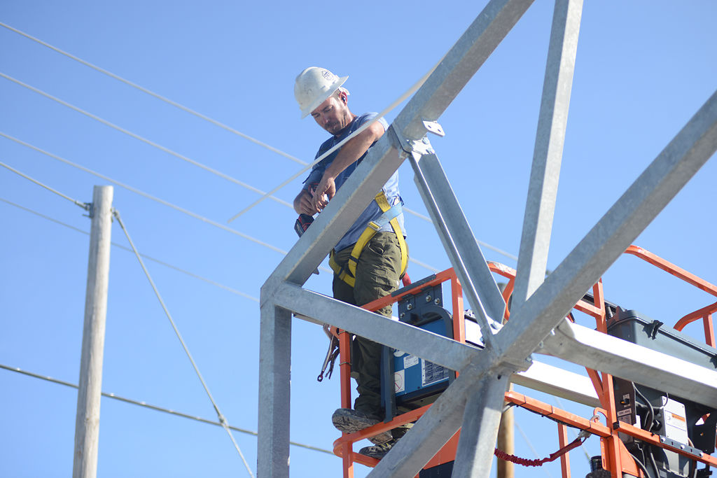 Construction worker Aaron Oakley drills guide holes in the frame of the new building for the Columbia Canine Sports Center on Thursday,